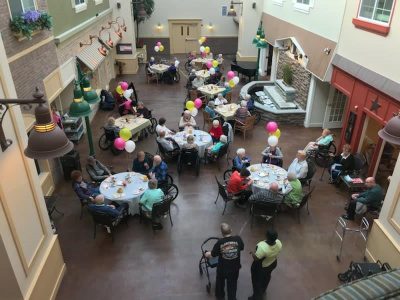 Upper view of people sitting at Tables .