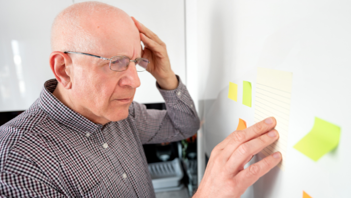 a gentleman looking confused and holding his head