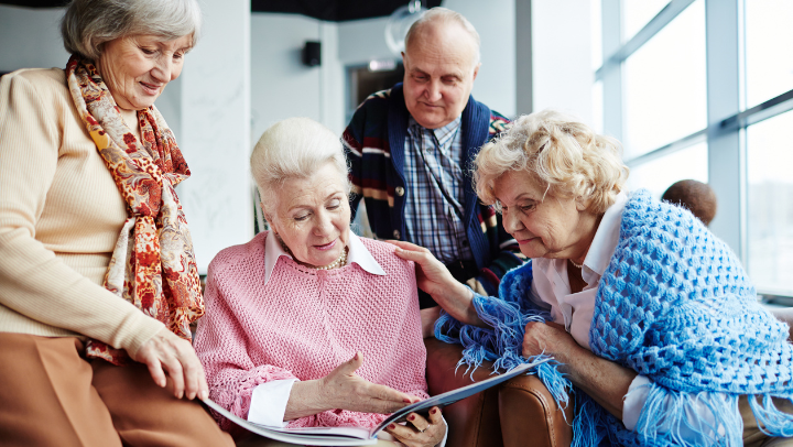 a group of seniors friends reading together 