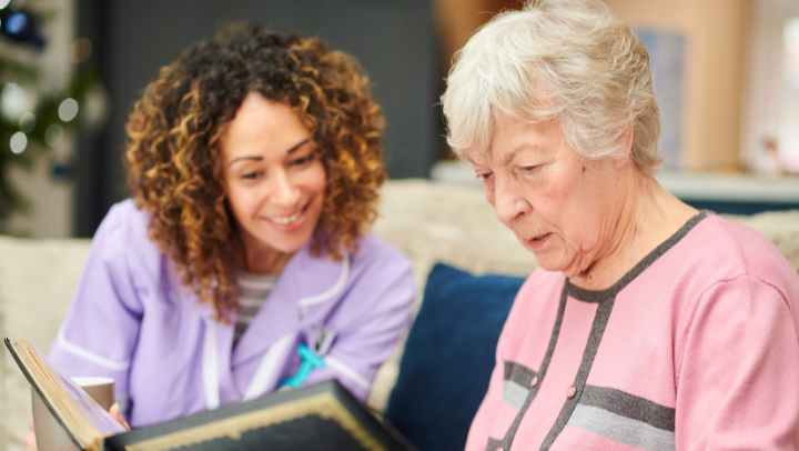 a nurse reading with a senior lady